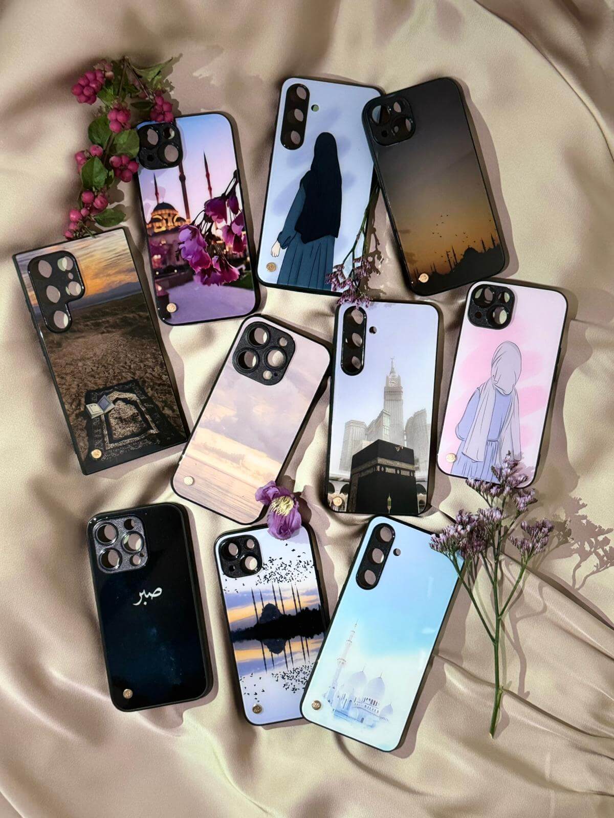 An aesthetically pleasing display of various Ummahcase phone case designs, showcasing a vibrant collection of Islamic-inspired patterns and themes for iPhone and Samsung models.