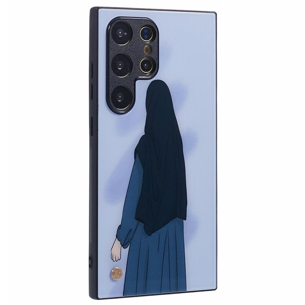 A light blue smartphone case features an illustration of a woman wearing a dark blue hijab and abaya, viewed from behind. 