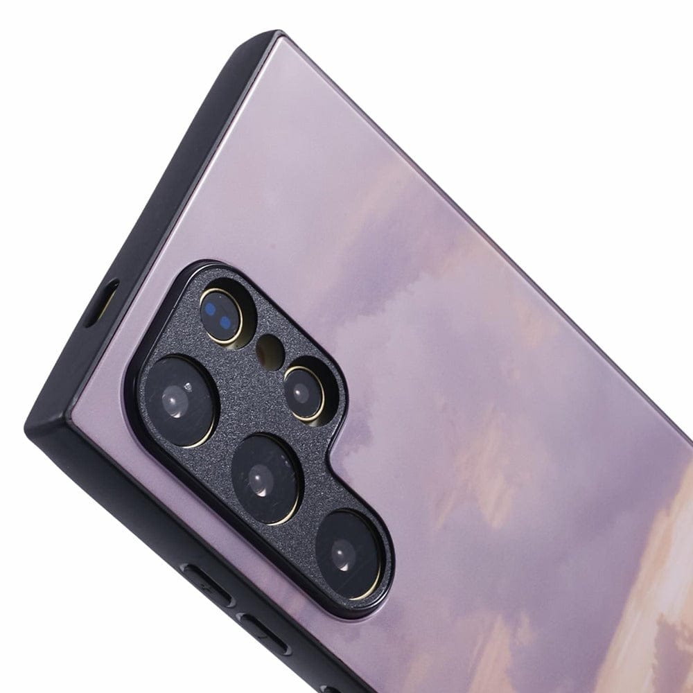 A smartphone with a purple and pink sunset case featuring an ocean view with subtle cloud formations. 