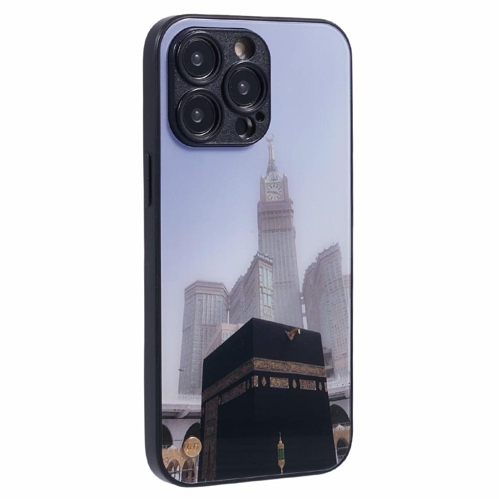 A smartphone with a protective case featuring an image of the Kaaba at the center, with the Abraj Al Bait clock tower in the background, both located in Mecca, Saudi Arabia. 