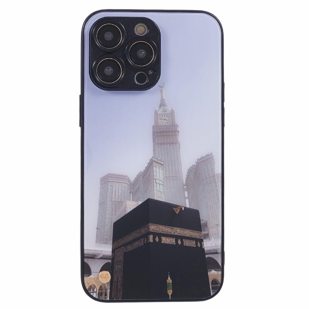 A smartphone with a protective case featuring an image of the Kaaba at the center, with the Abraj Al Bait clock tower in the background, both located in Mecca, Saudi Arabia. 