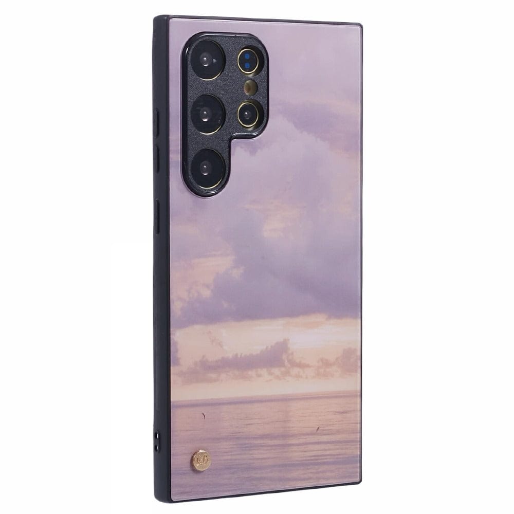 A smartphone with a purple and pink sunset case featuring an ocean view with subtle cloud formations. 