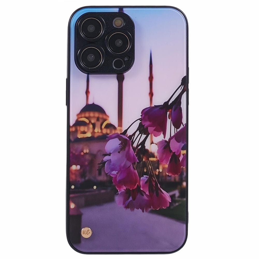 A smartphone case with a design featuring rose petals in the foreground and a mosque with multiple minarets in the background, set against a twilight sky.