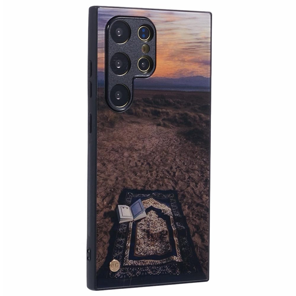 Islamic phone case featuring a prayer mat on the ground with a peaceful outdoor scene at sunset.