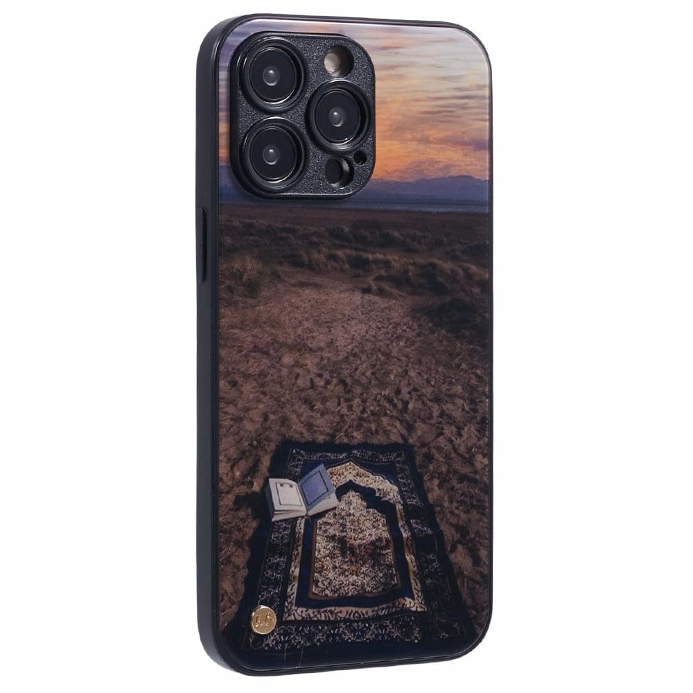 Islamic phone case featuring a prayer mat on the ground with a peaceful outdoor scene at sunset.