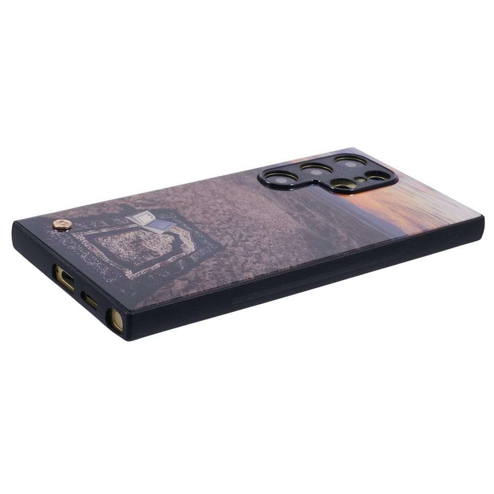 Islamic phone case featuring a prayer mat on the ground with a peaceful outdoor scene at sunset.