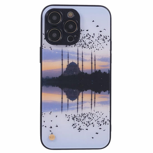 A smartphone case depicting a scenic view of a mosque with tall minarets at sunset. Numerous birds are flying in the sky, and the mosque is reflected in a body of water below, creating a symmetrical and tranquil composition.