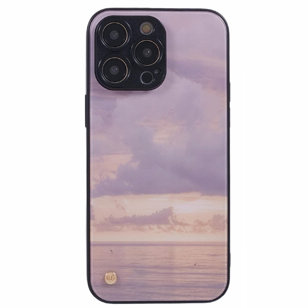 A smartphone with a purple and pink sunset case featuring an ocean view with subtle cloud formations. 