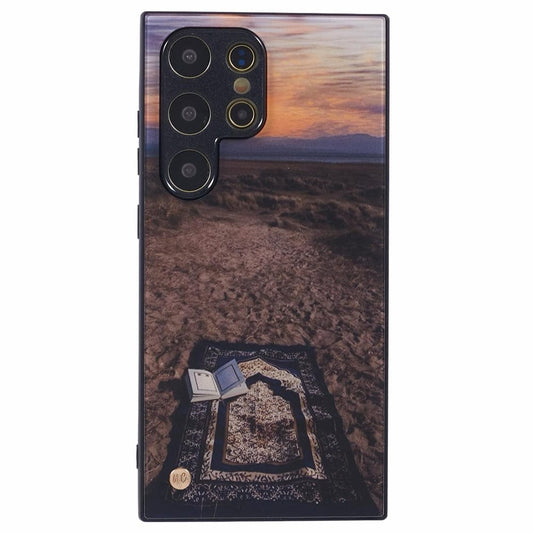 Islamic phone case featuring a prayer mat on the ground with a peaceful outdoor scene at sunset.